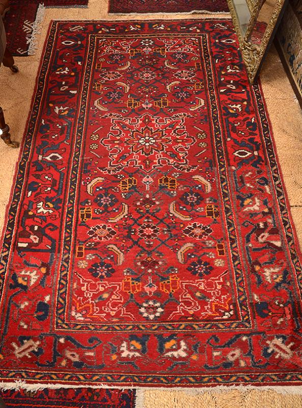 Appraisal: AN IRANIAN WOOL CARPET with geometric borders with Islamic fretwork