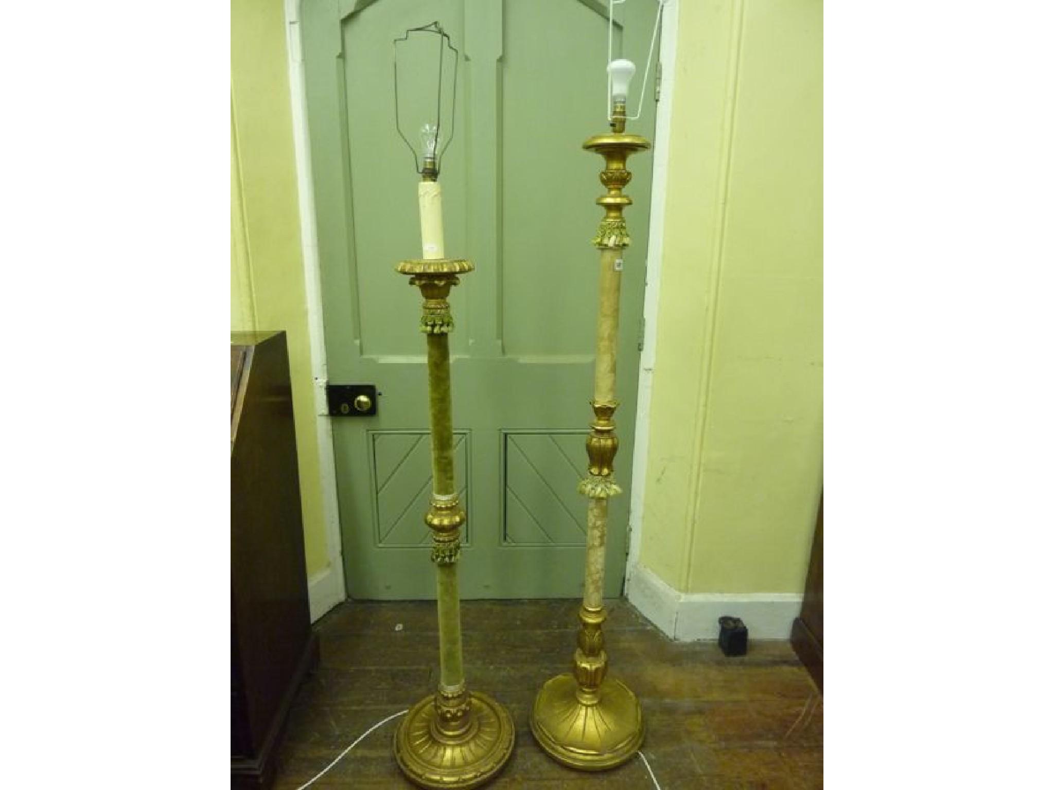 Appraisal: A gilt wood standard lamp with partially upholstered column and