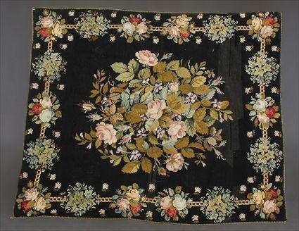 Appraisal: NEEDLEWORK RUG Centered by a colorful floral spray within chain