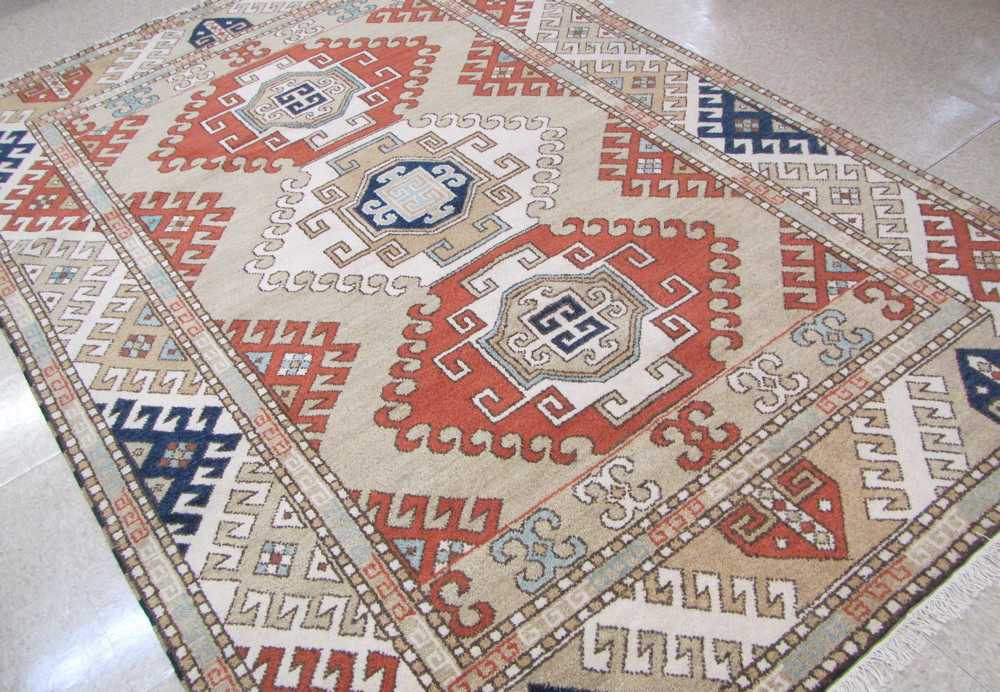 Appraisal: HAND KNOTTED ORIENTAL CARPET Indo-Caucasian triple geometric medallion design '