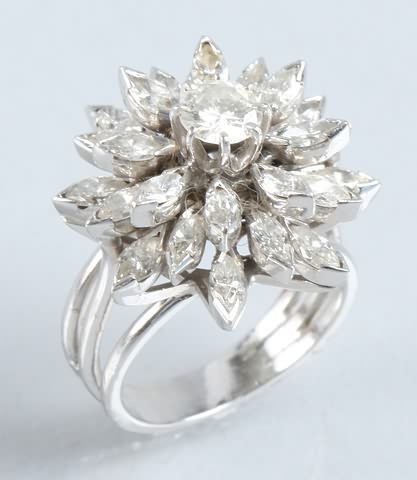 Appraisal: KW gold diamond cluster ring One round brilliant cut diamond