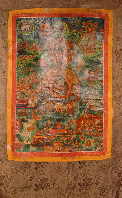 Appraisal: A TIBETAN THANKA the polychrome central panel with detailed Deity