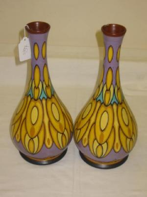 Appraisal: A PAIR OF GOUDA VASES of bottle form painted with