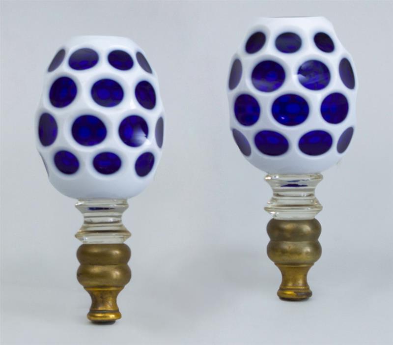 Appraisal: PAIR OF OVERLAY BLUE GLASS OVOID FINIALS With brass collars