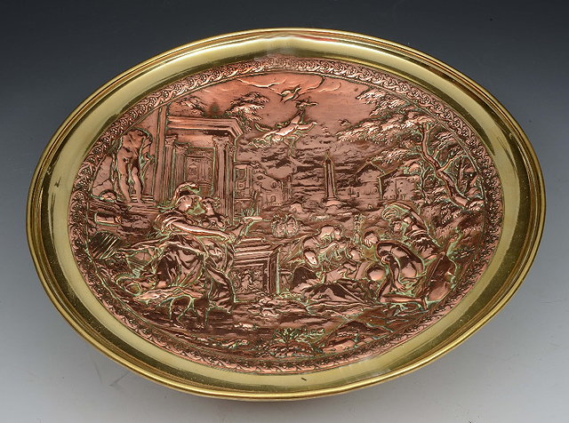 Appraisal: A VICTORIAN BRASS AND COPPER EMBOSSED TAZZA with classical figure