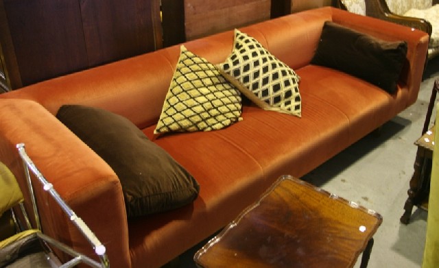 Appraisal: A modern orange velvet upholstered three seater sofa