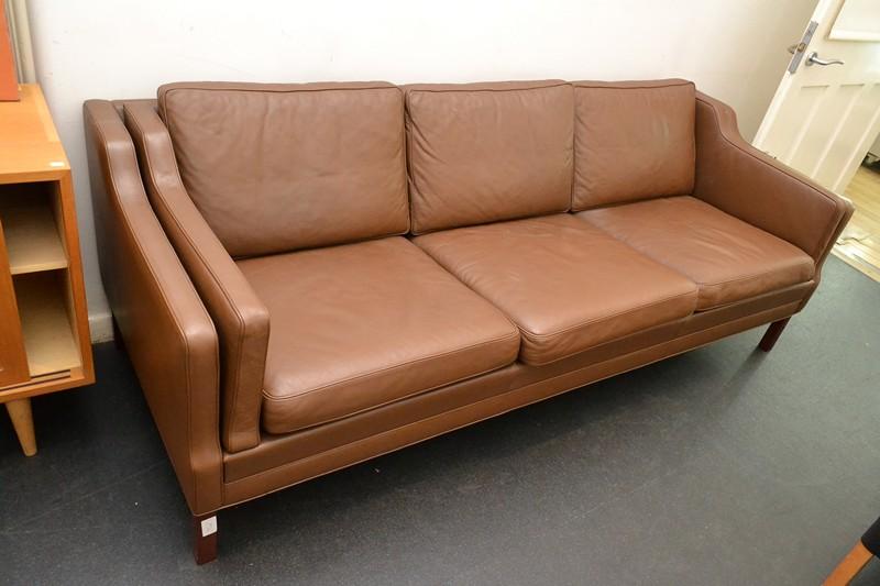 Appraisal: A DANISH BROWN THREE SEAT SOFA A DANISH BROWN THREE