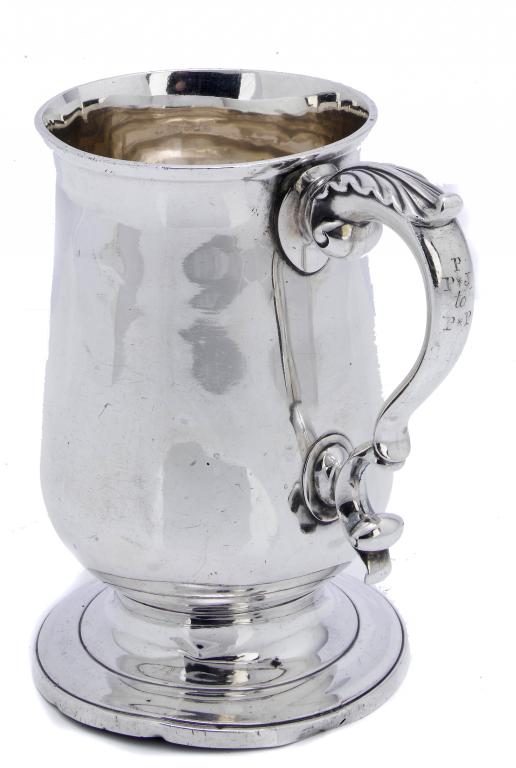 Appraisal: A GEORGE III BALUSTER MUG with leaf capped double scroll