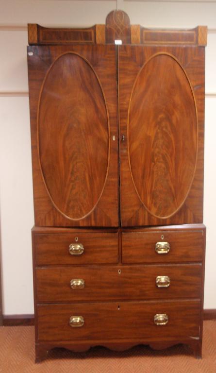 Appraisal: A George III mahogany press cupboard with string and panel