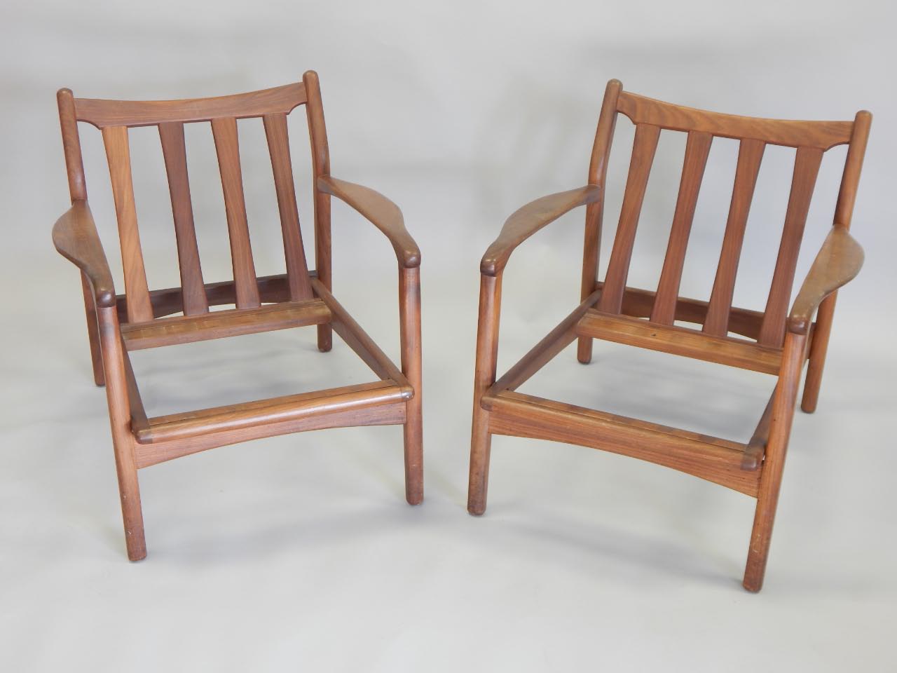 Appraisal: A pair of s Retro style teak armchairs each with