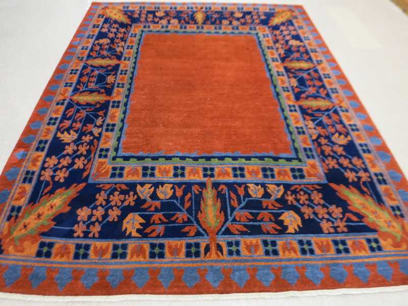 Appraisal: A CONTEMPORARY HAND KNOTTED NEPALI CARPET centering a plain rectangular