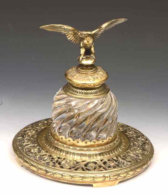 Appraisal: A VICTORIAN LARGE BRASS AND GLASS INKWELL the lid surmounted