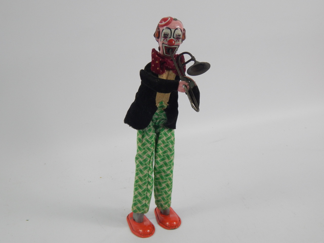 Appraisal: A tin plate model of a trombone playing clown cm