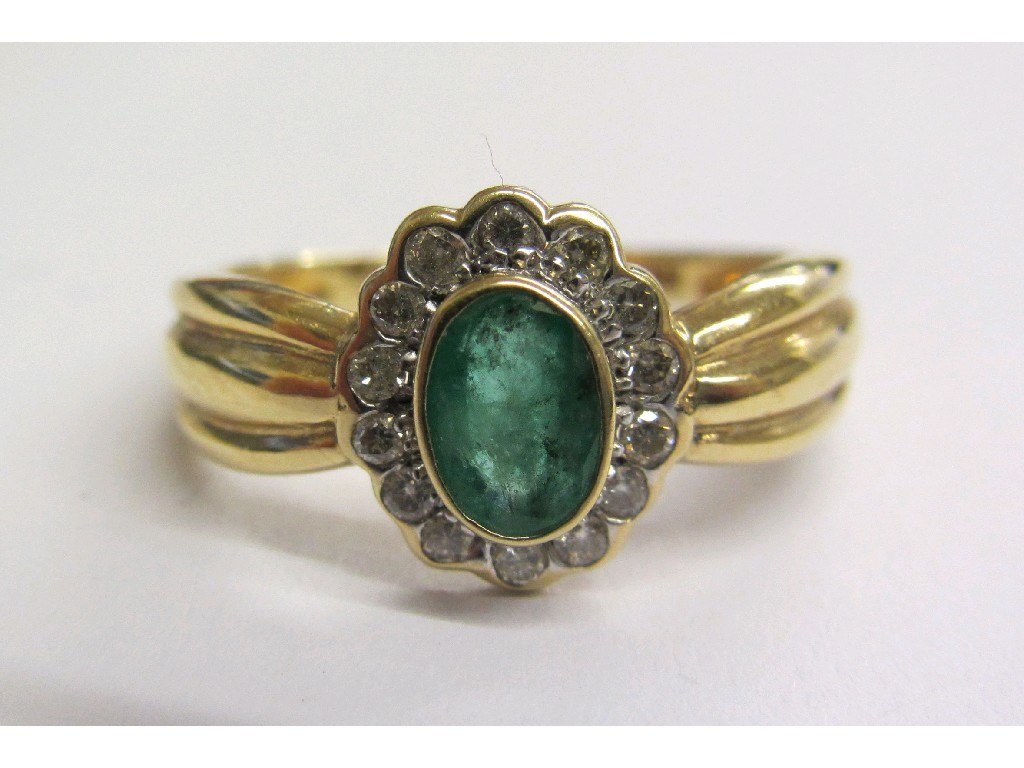 Appraisal: Eighteen carat gold emerald and diamond cluster ring