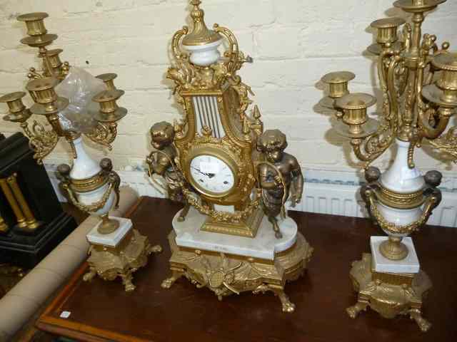 Appraisal: A CONTINENTAL STYLE GILT METAL MANTEL CLOCK GARNITURE DE CHEMIN