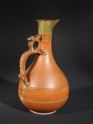 Appraisal: A Watcombe Torquay terracotta jug with brass neck and cover