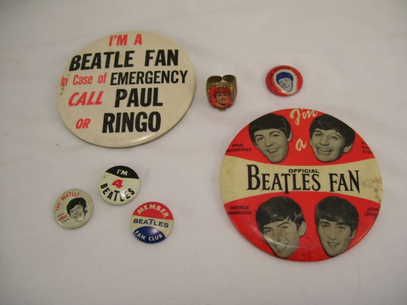 Appraisal: Beatles Memorabilia Lot Includes six buttons and one ring Pinback