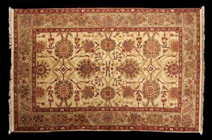 Appraisal: OUSHAK DESIGN CARPET The ivory field with lotus overlay within