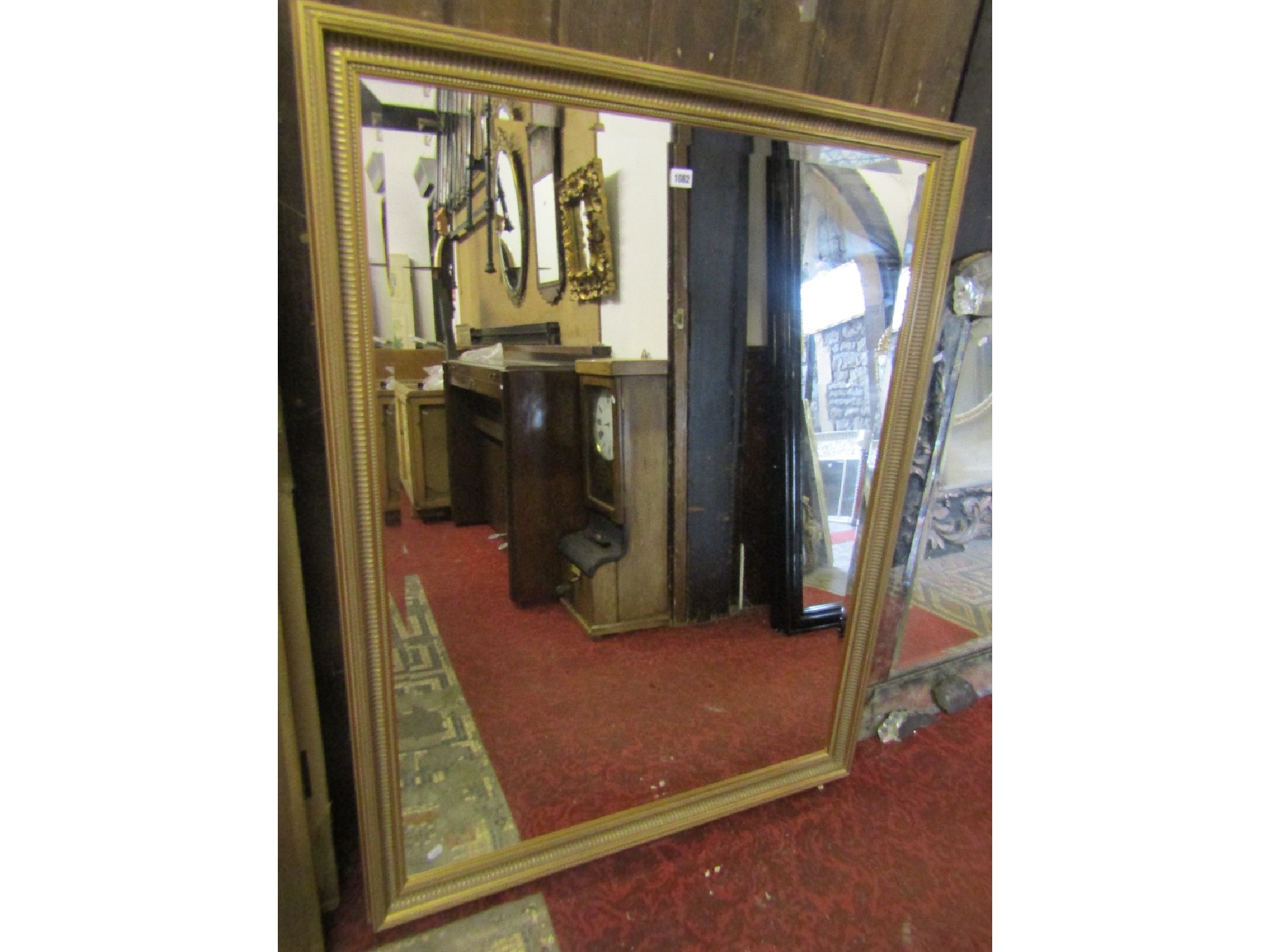 Appraisal: A contemporary wall mirror of rectangular form with bevelled edge