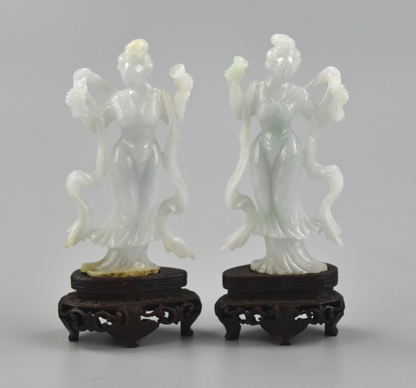 Appraisal: Two elegant carved jadeite sculptures of ladies with flowing pattern