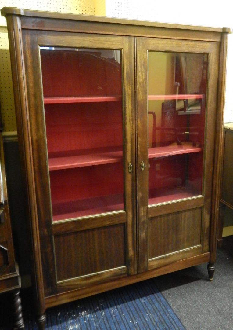 Appraisal: A Continental mahogany display cabinet with two glazed doors flanked