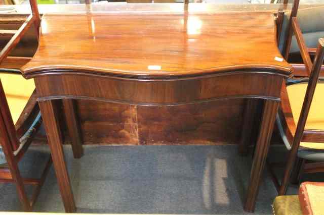 Appraisal: A GEORGE III MAHOGANY SERPENTINE FOLD OVER TOP CARD TABLE