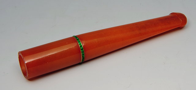 Appraisal: AN AMBER CHEROOT HOLDER set with a band of green