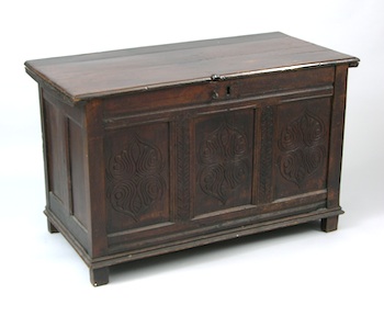 Appraisal: An Early Continental Hand-Hewn Dark Oak Coffer An early hand-hewn