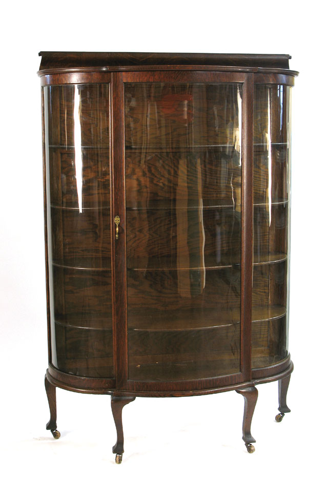 Appraisal: AN OAK AND CURVED GLASS CHINA DISPLAY CABINET American c