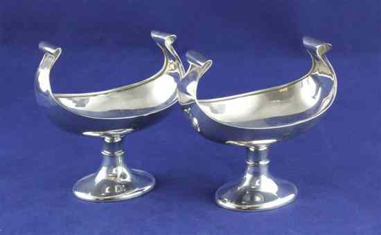 Appraisal: A stylish pair of George V silver boat shaped pedestal