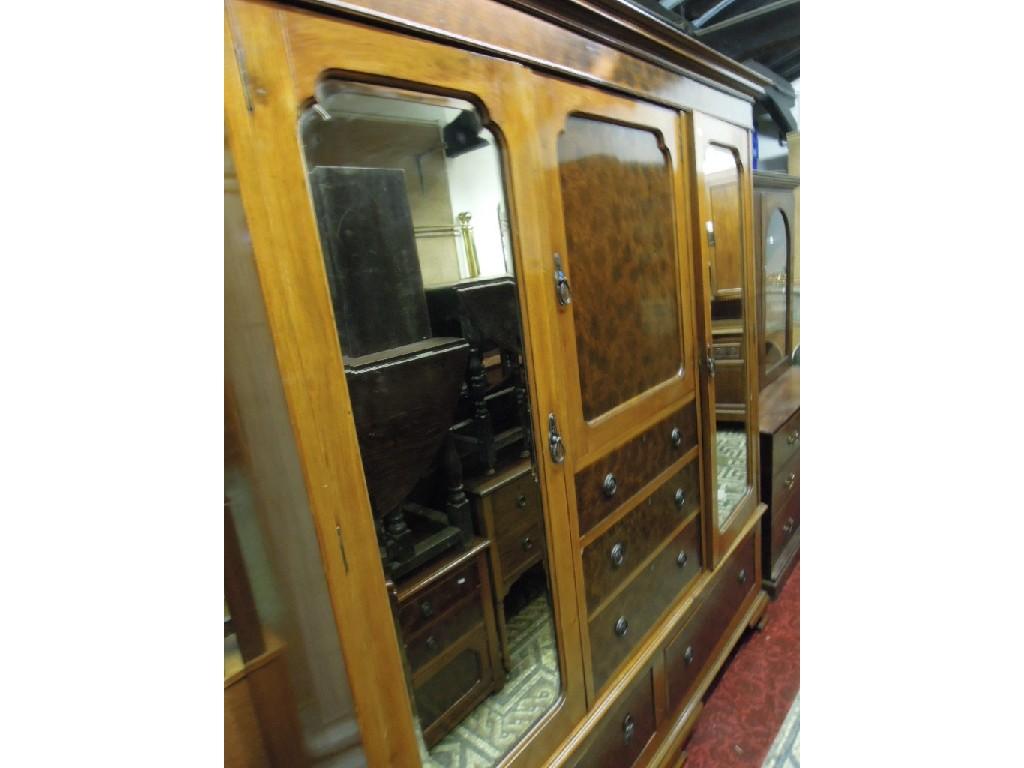 Appraisal: An Edwardian walnut triple compactum wardrobe enclosed by an arrangement