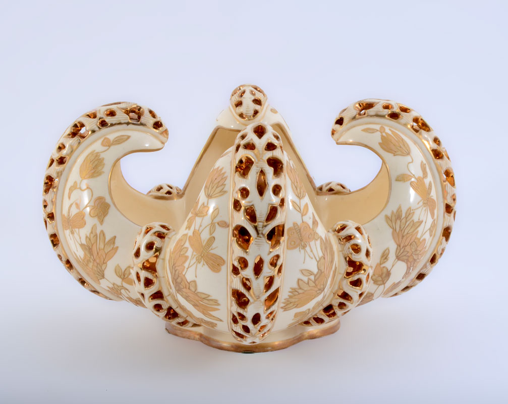 Appraisal: FISCHER ZSOLNAY RETICULATED FRUIT BOWL Square bowl with upswept arms