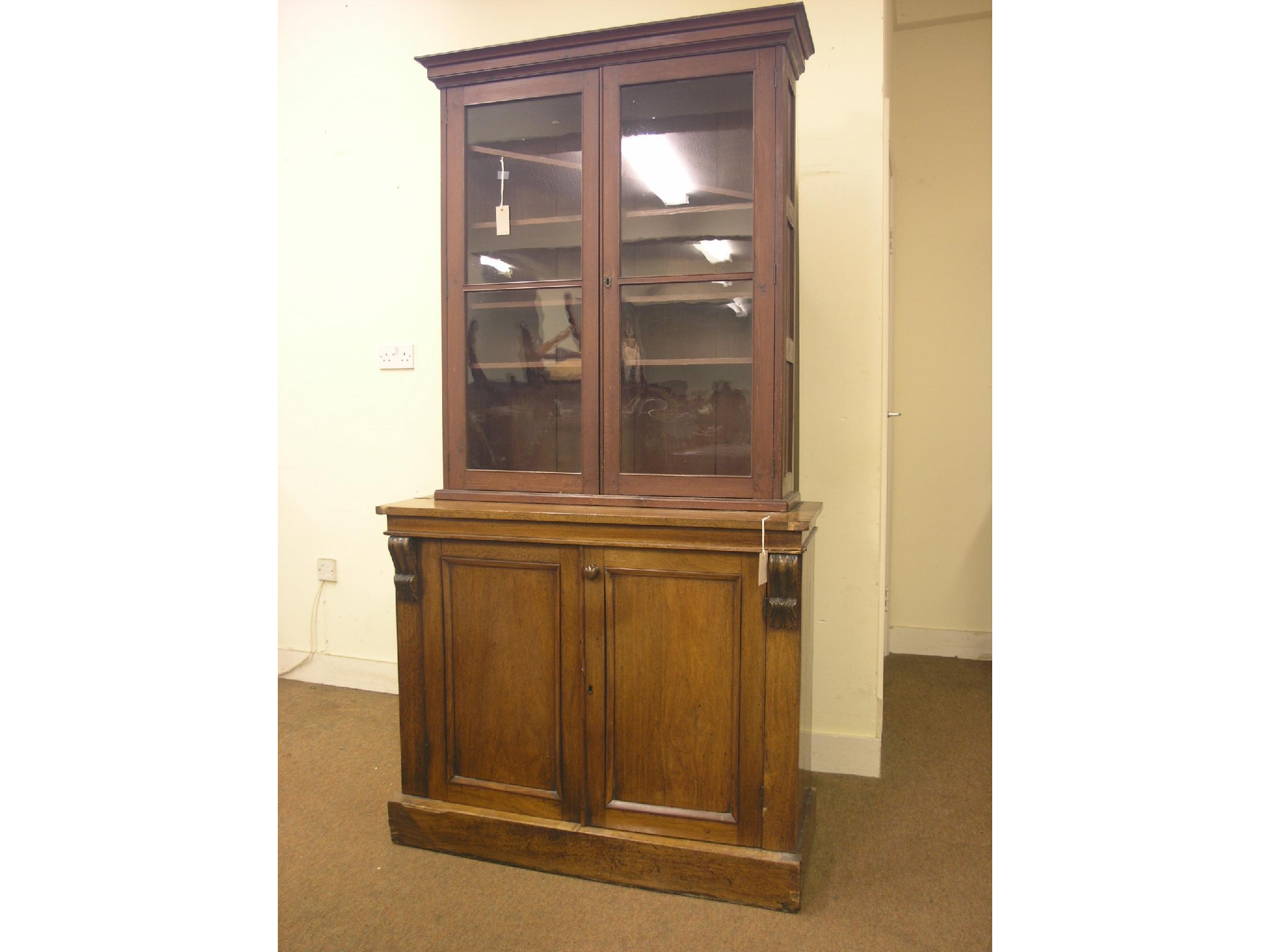 Appraisal: A Victorian tall bookcase marriage panelled mahogany cupboard base with