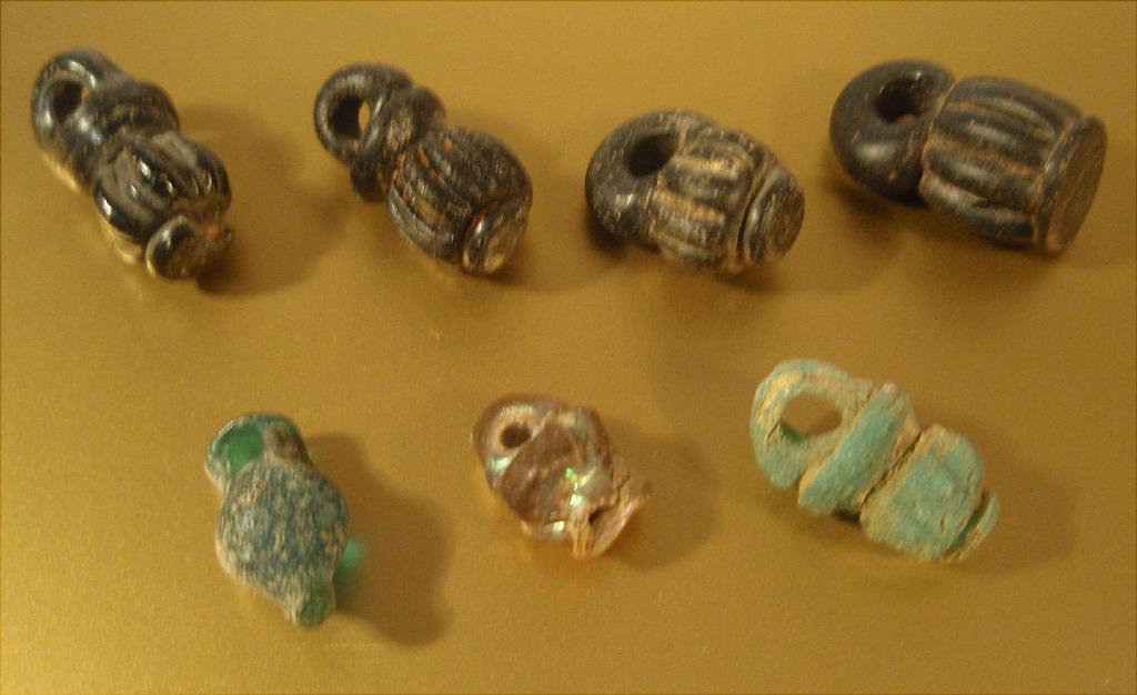 Appraisal: Seven late Roman ribbed jar pendants four in black glass