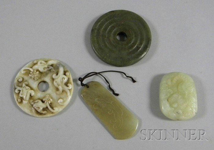 Appraisal: Four Carved Stone Asian Pendants including green white and gray