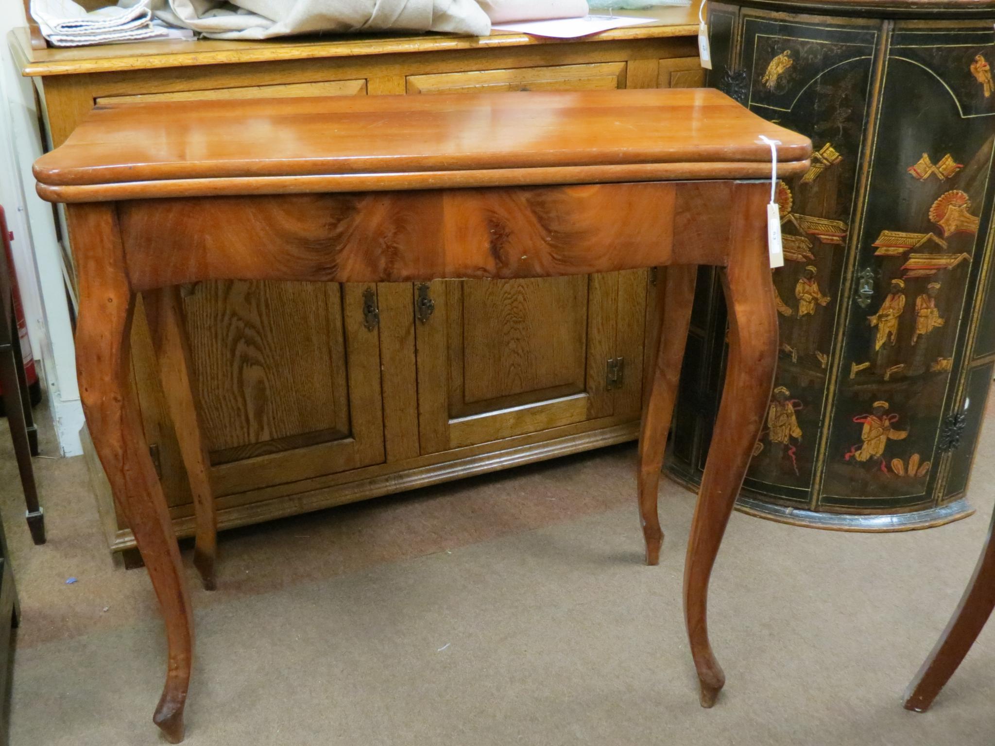 Appraisal: A late th century continental mahogany tea table hinged serpentine-shaped