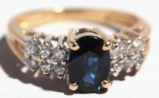 Appraisal: K Gold Sapphire Diamond Ring A sapphire oval brilliant flanked