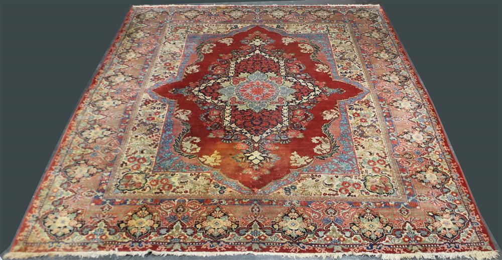 Appraisal: LARGE PERSIAN SAROUK WOOL RUG having a central flower within