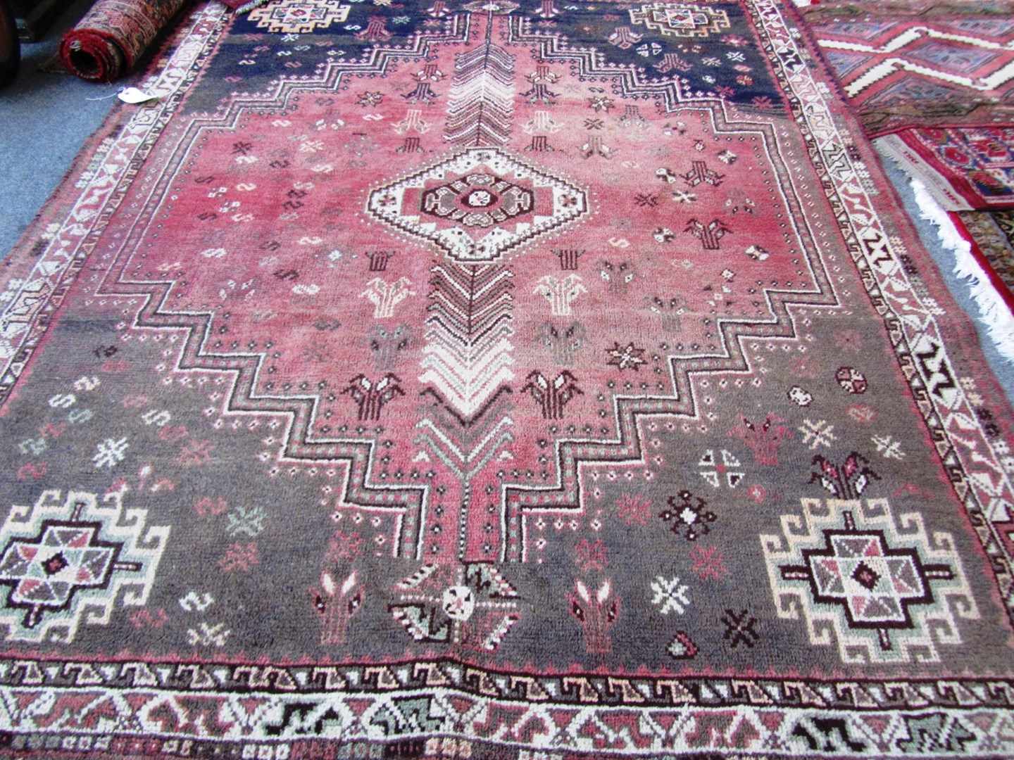 Appraisal: A Shiraz carpet the madder field with a single medallion