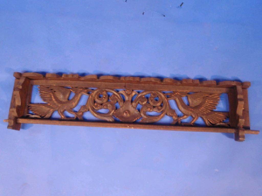 Appraisal: A stained wood wall rack pierced with a frieze of