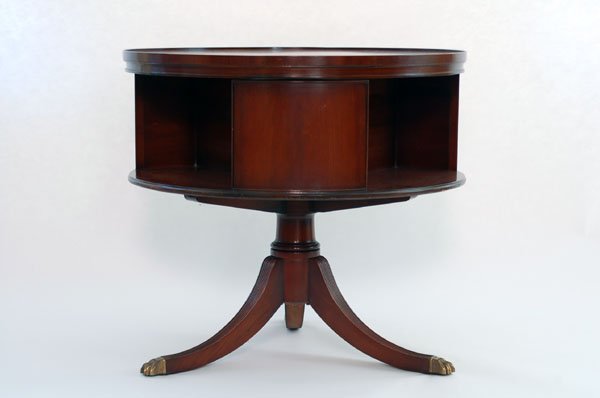 Appraisal: Drum table with rotating shelf Round top with three section