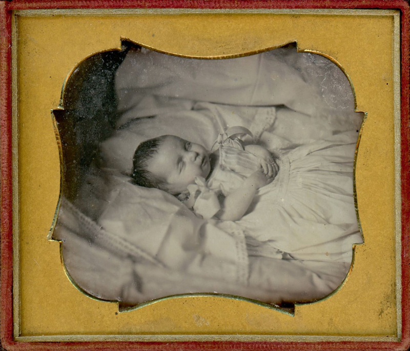 Appraisal: s POSTMORTEM DAGUERREOTYPE BABY WITH BOWS Sixth plate daguerreotype Here's