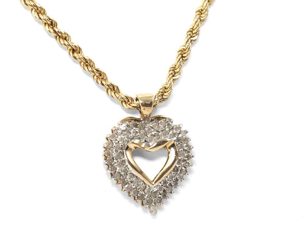 Appraisal: DIAMOND HEART NECKLACE K yellow gold heat pendant contains round