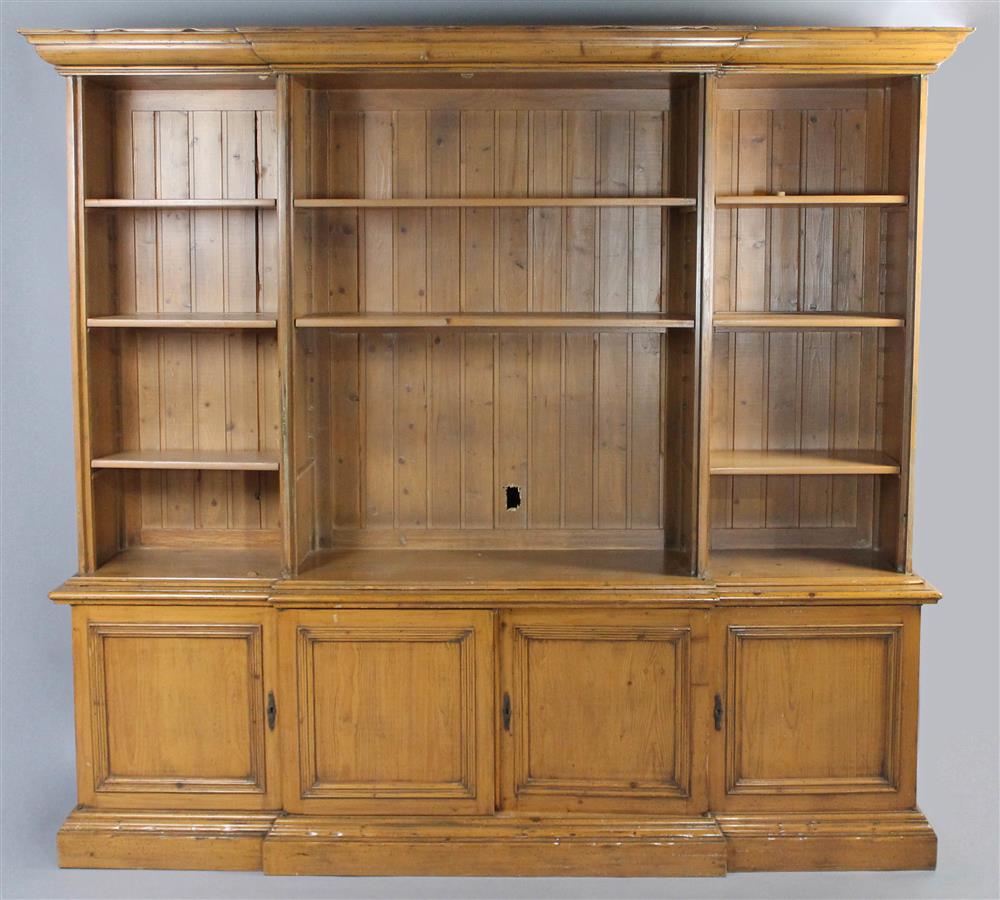 Appraisal: LARGE PINE BREAKFRONT BOOKCASE having a carved pediment over a