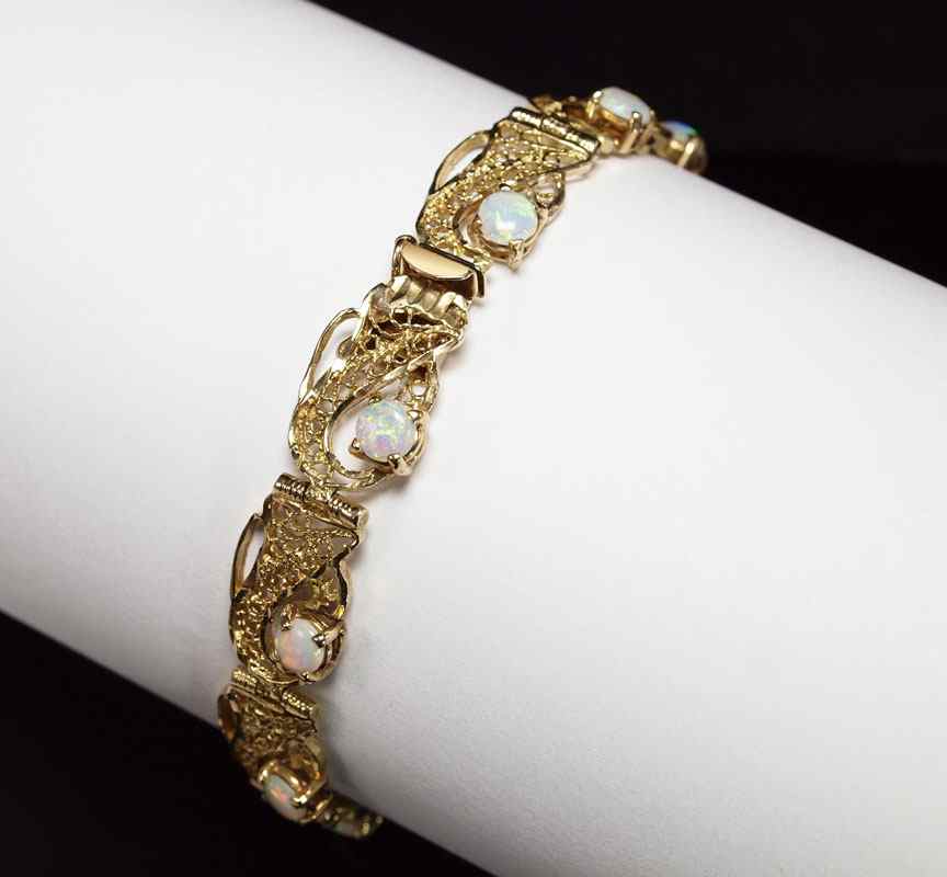 Appraisal: K OPAL BRACELET K filigree link bracelet contains round cabochon