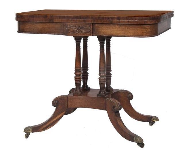 Appraisal: A REGENCY ROSEWOOD FOLD OVER CARD TABLE with carved anthemion