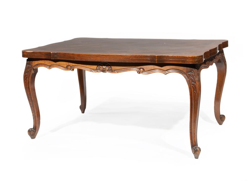 Appraisal: French Provincial Carved Oak Draw Leaf Dining Table serpentine top