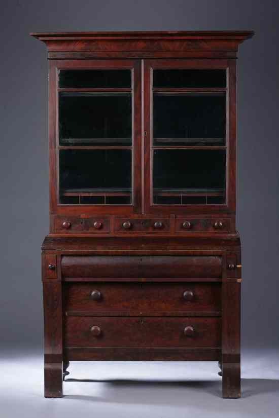 Appraisal: AMERICAN EMPIRE FLAME MAHOGANY SECRETARY BOOKCASE Circa Upper section projected