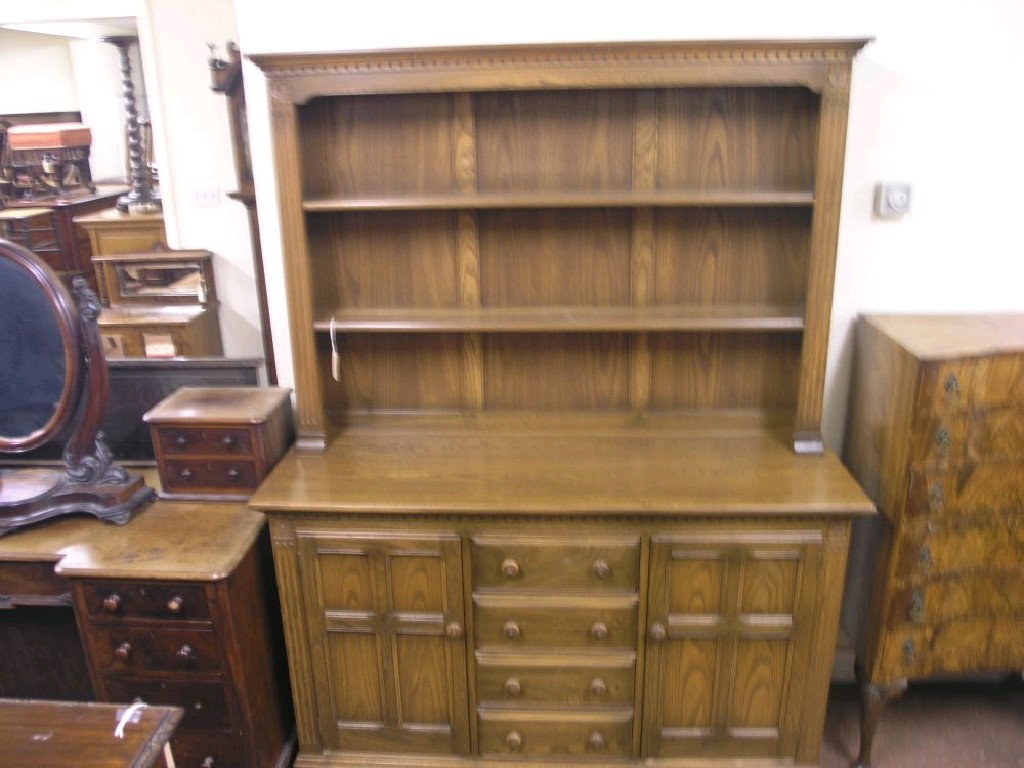 Appraisal: An Ercol elm Lancashire dresser two-shelf plate rack above panelled