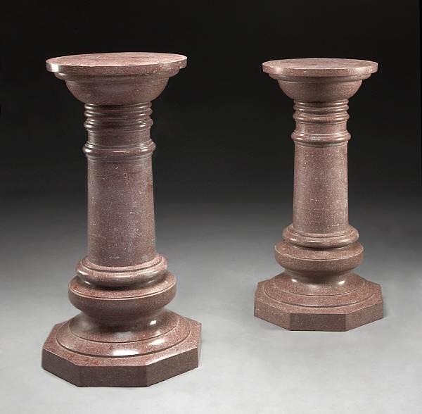 Appraisal: A pair of Romanesque style rouge granite pedestals The circular